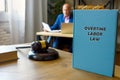 Attorney holds OVERTIME LABOR LAW book. FederalÃÂ overtime lawsÃÂ are set forth in the FairÃÂ LaborÃÂ StandardsÃÂ ActÃÂ FLSA Royalty Free Stock Photo